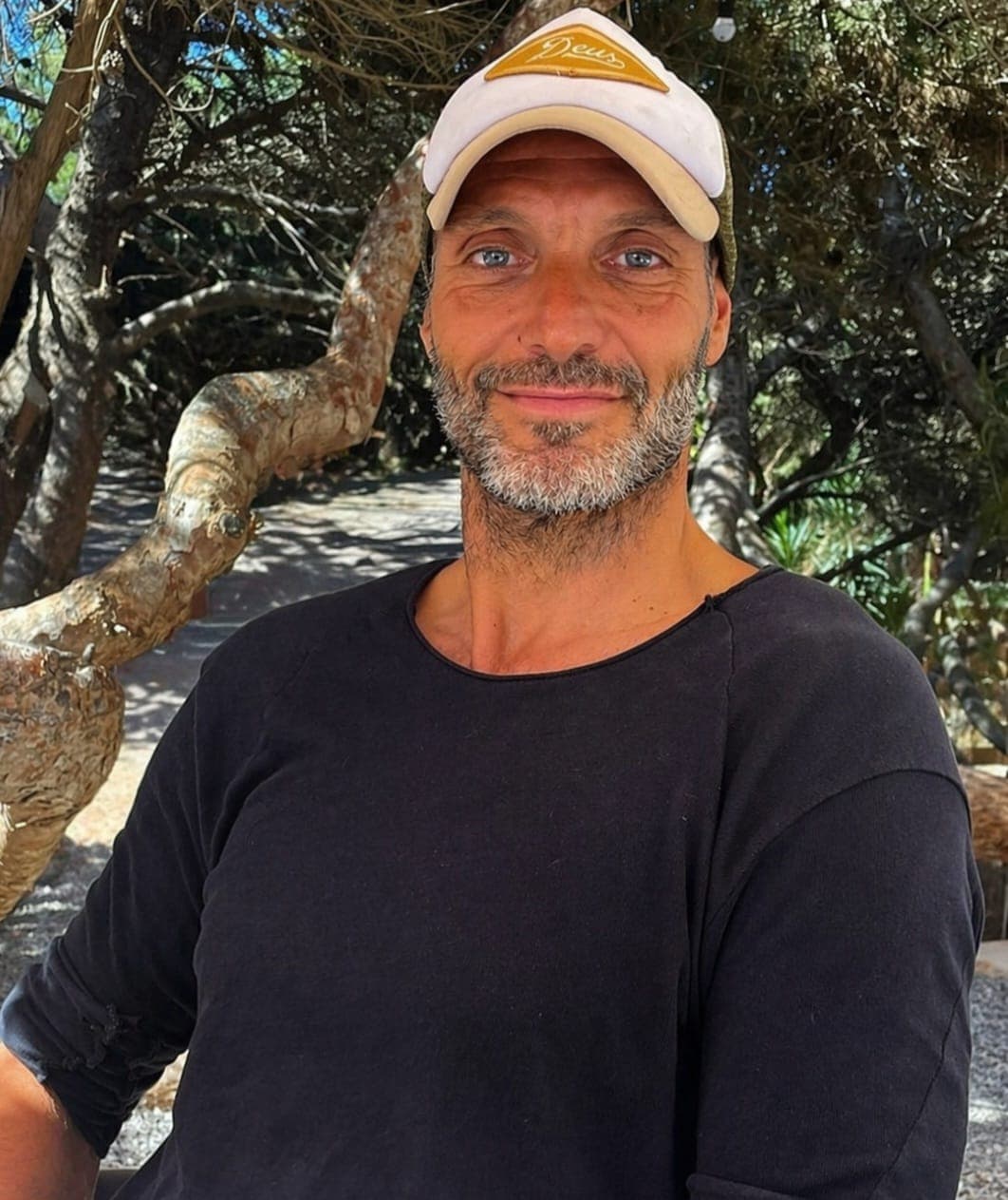 Maxim Rettich, founder of Boys To Men Retreat, smiling outdoors in a cap