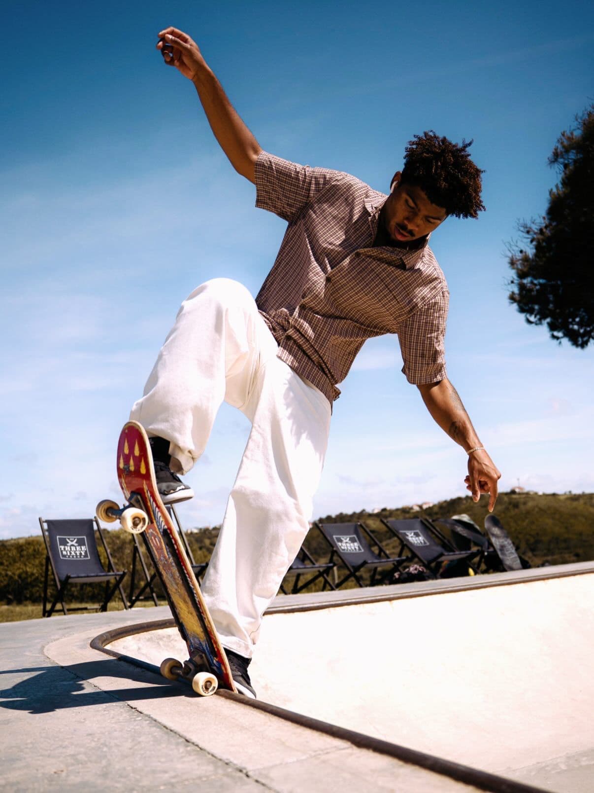 Rafa, skate coach, riding the edge of a bowl on his skateboard